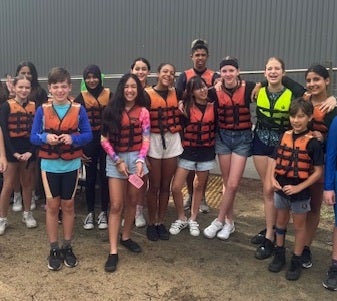 A group of happy students in life vests