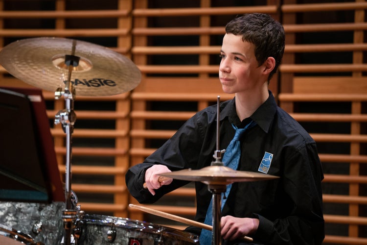 A student playing drums