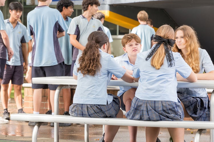 Students sit outside and talk