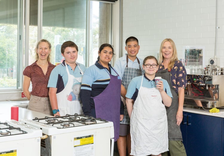Four students and two teachers learn to make coffee