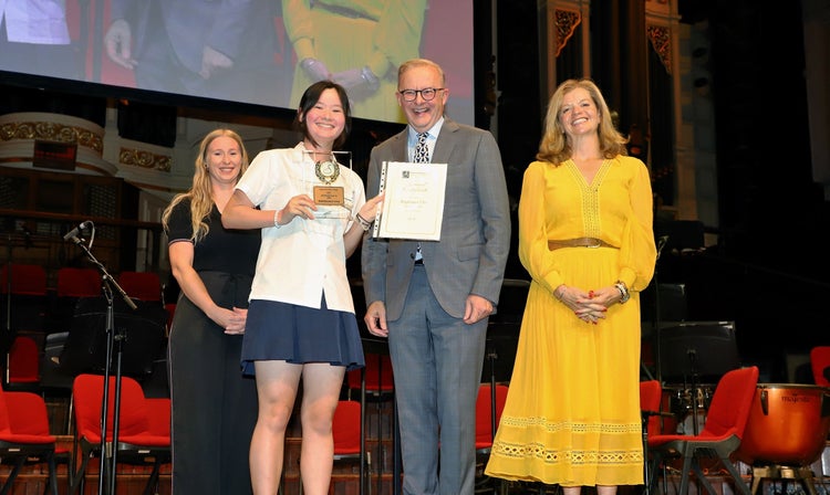 A student receives an award from Prime Minister Anthony Albanese