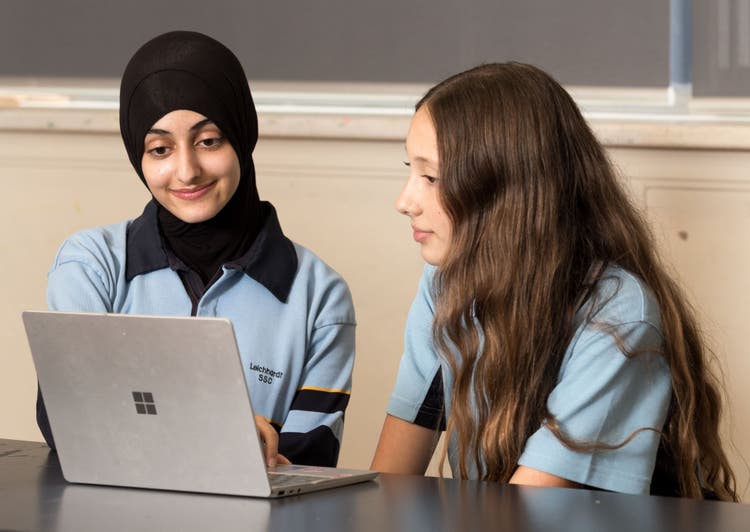 Two students looking at a computer